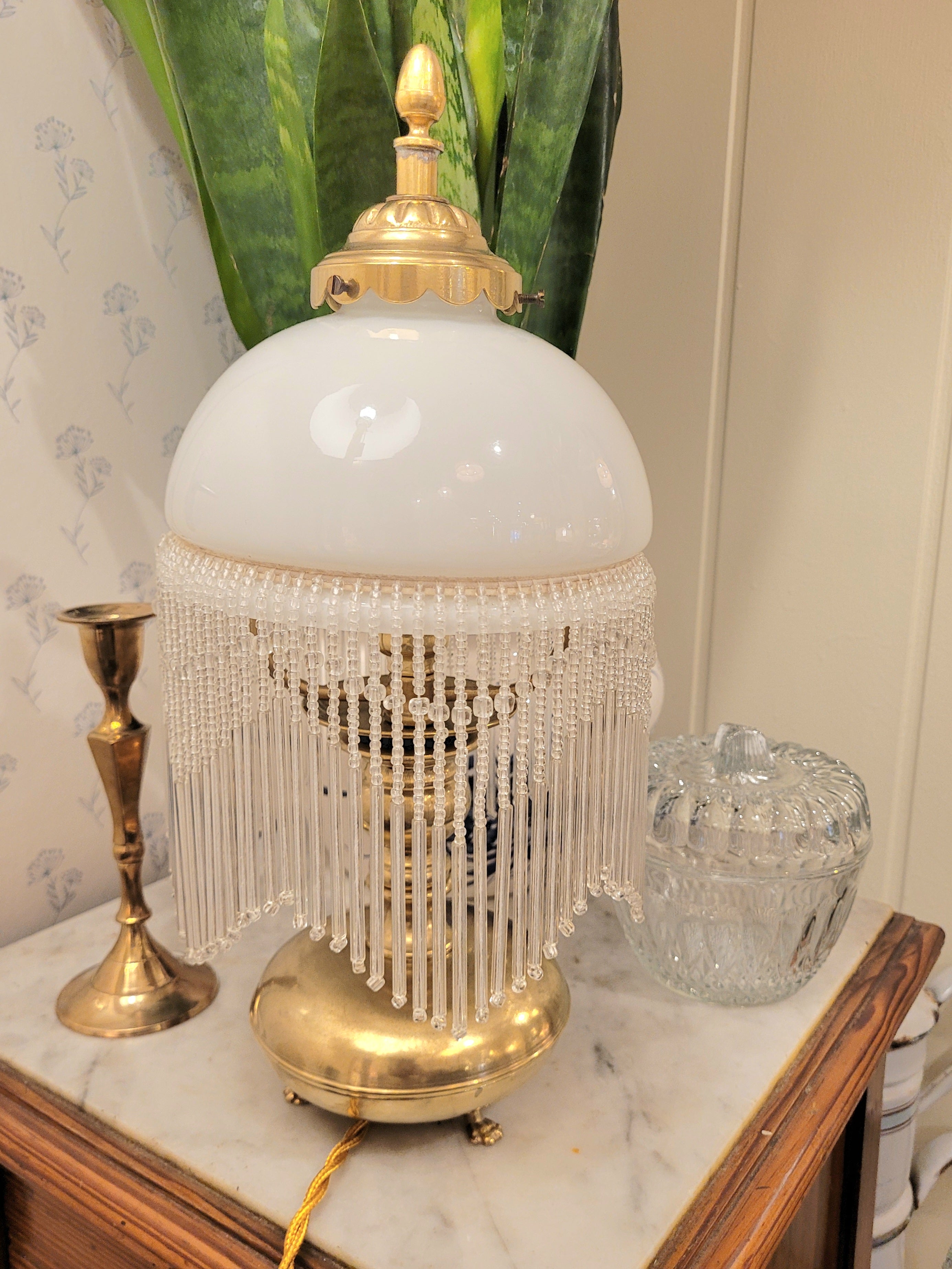 Superbe lampe, pied en laiton reposant sur 3 petits pieds en forme de pattes, abat-jour en opaline blanche et pampilles transparentes